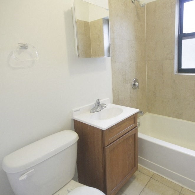 a bathroom with a toilet and a sink and a tub