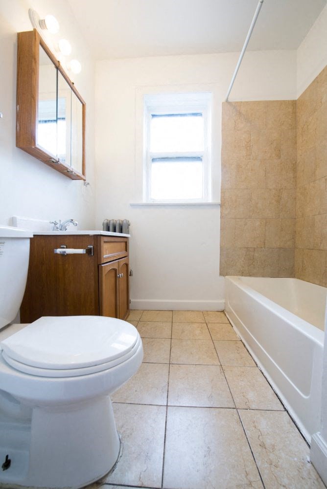 a bathroom with a toilet and a bath tub