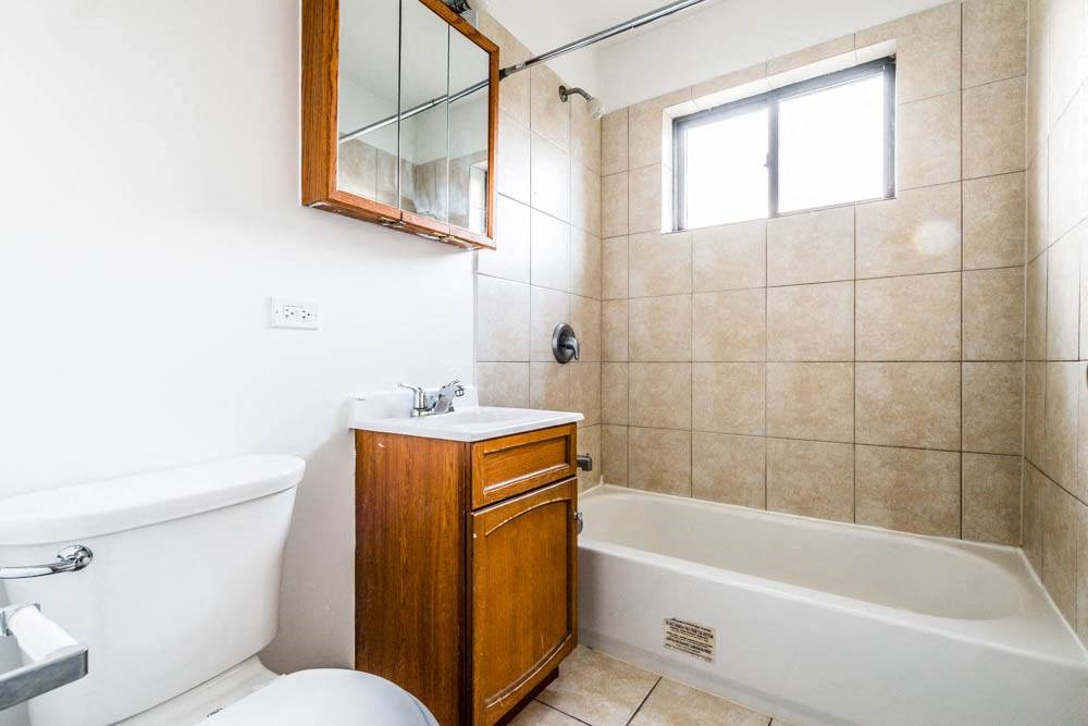 a bathroom with a toilet and a sink and a bath tub