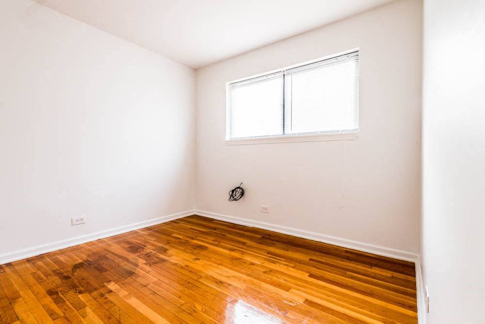 a room with a hard wood floor and a window