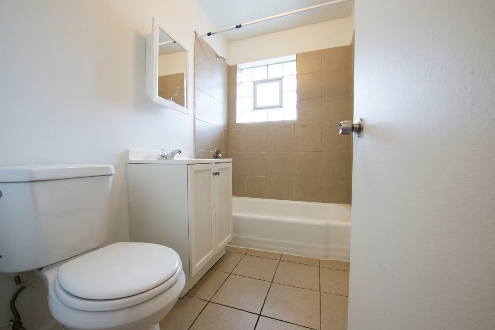 a bathroom with a toilet and a bath tub