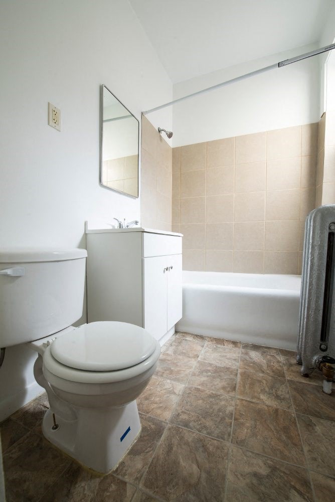 a bathroom with a toilet and a bath tub
