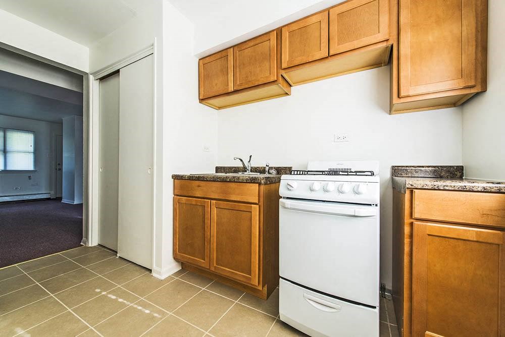 a kitchen with white appliances and wooden cabinets