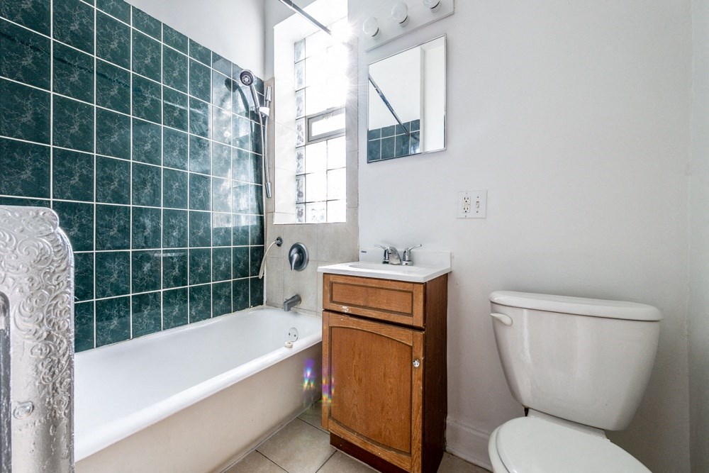 a bathroom with a toilet and a tub and a sink