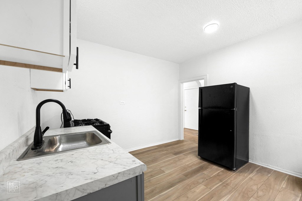 a kitchen with a sink and a refrigerator