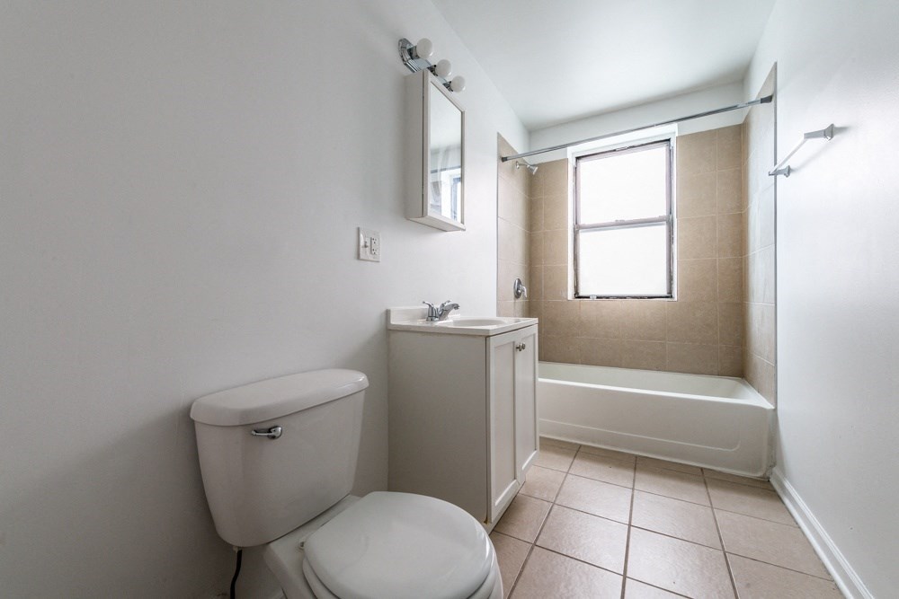 an empty bathroom with a toilet and a shower