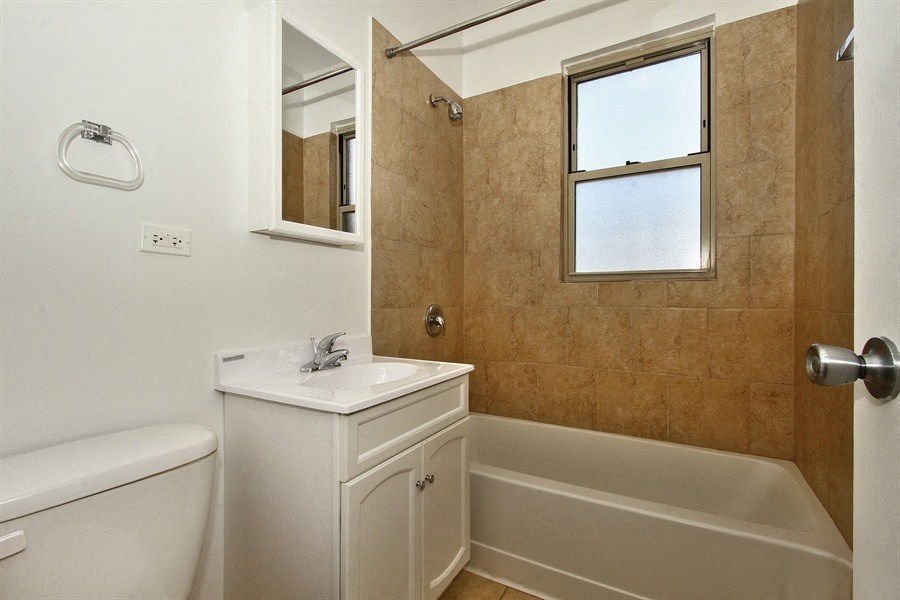 a bathroom with a sink toilet and a bath tub