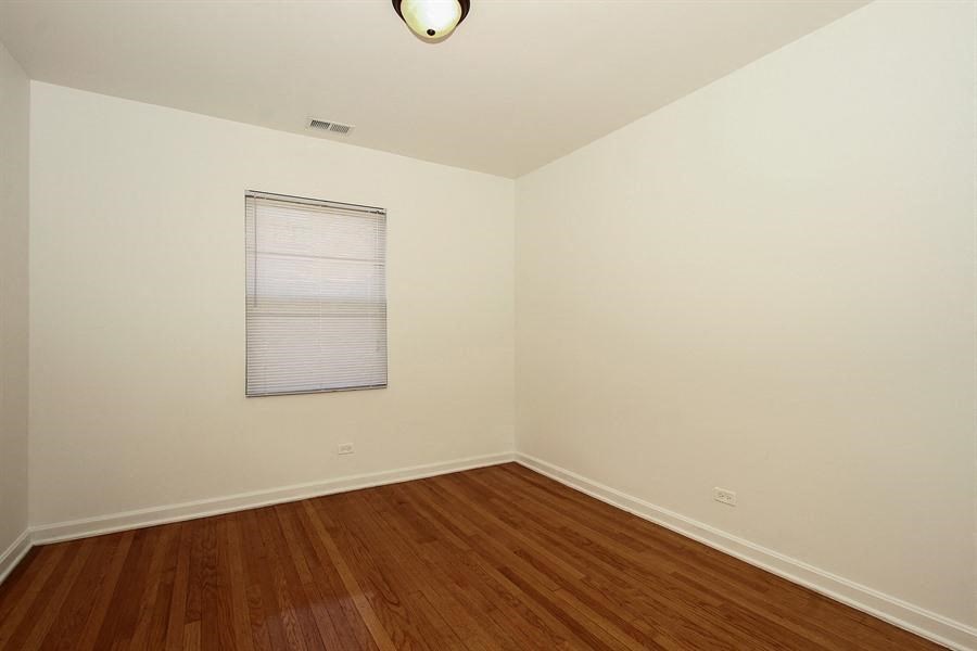 an empty room with a wood floor and a window