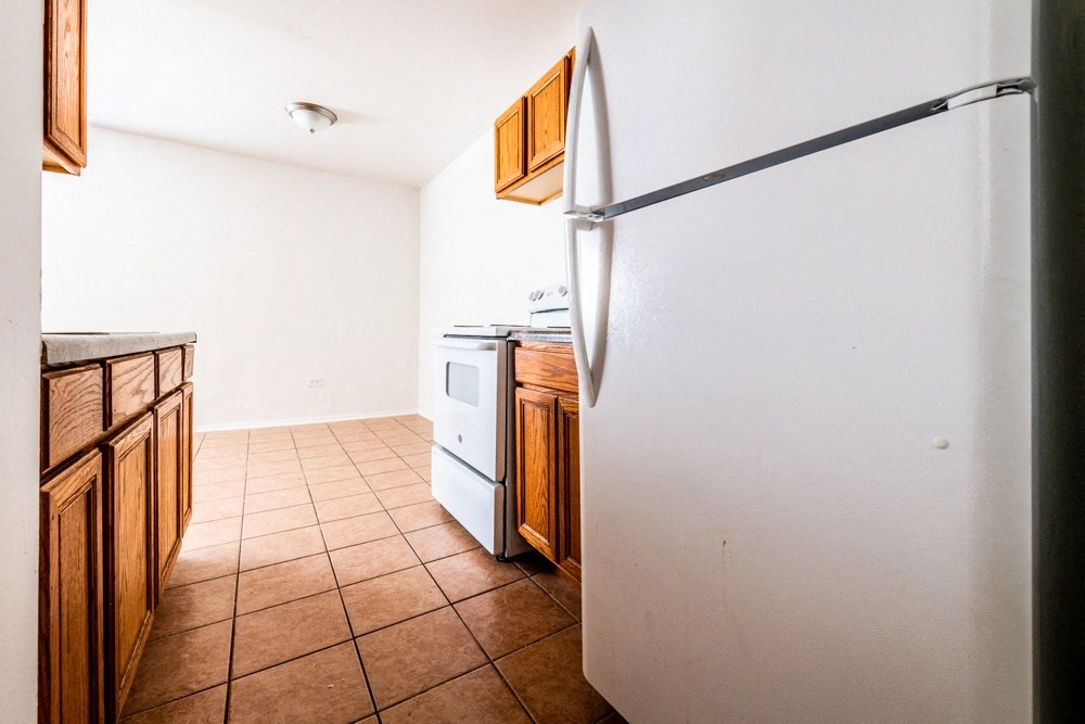 a kitchen with a refrigerator and a stove and a sink