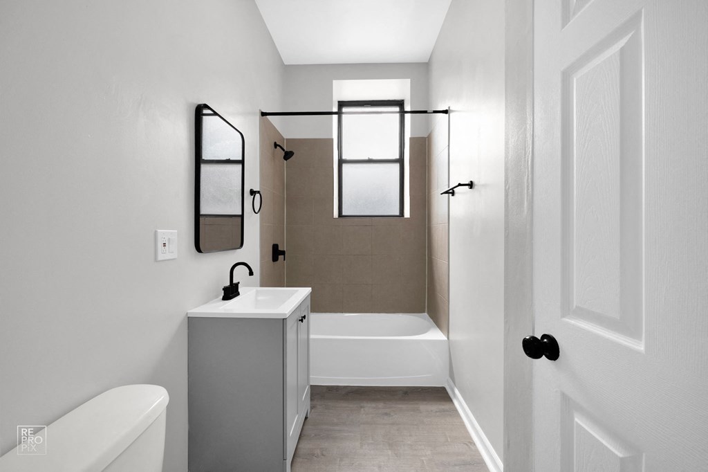 a bathroom with a sink and a bathtub in a 555 waverly unit