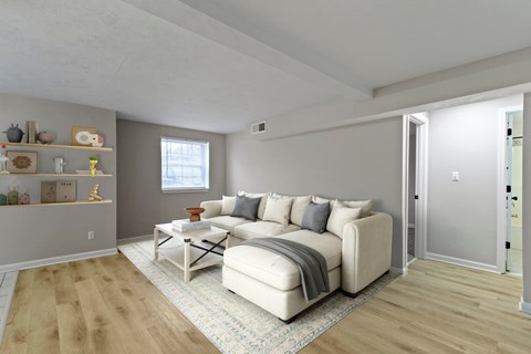 A living room with a white couch and a coffee table.