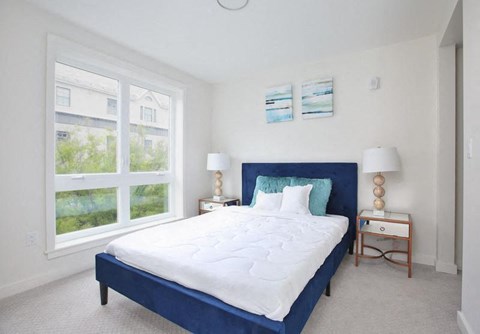 a bedroom with a large bed and a large window