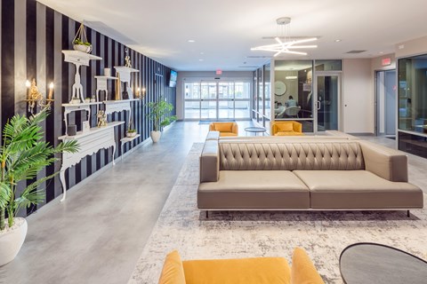 a lobby with couches and chairs and a large window