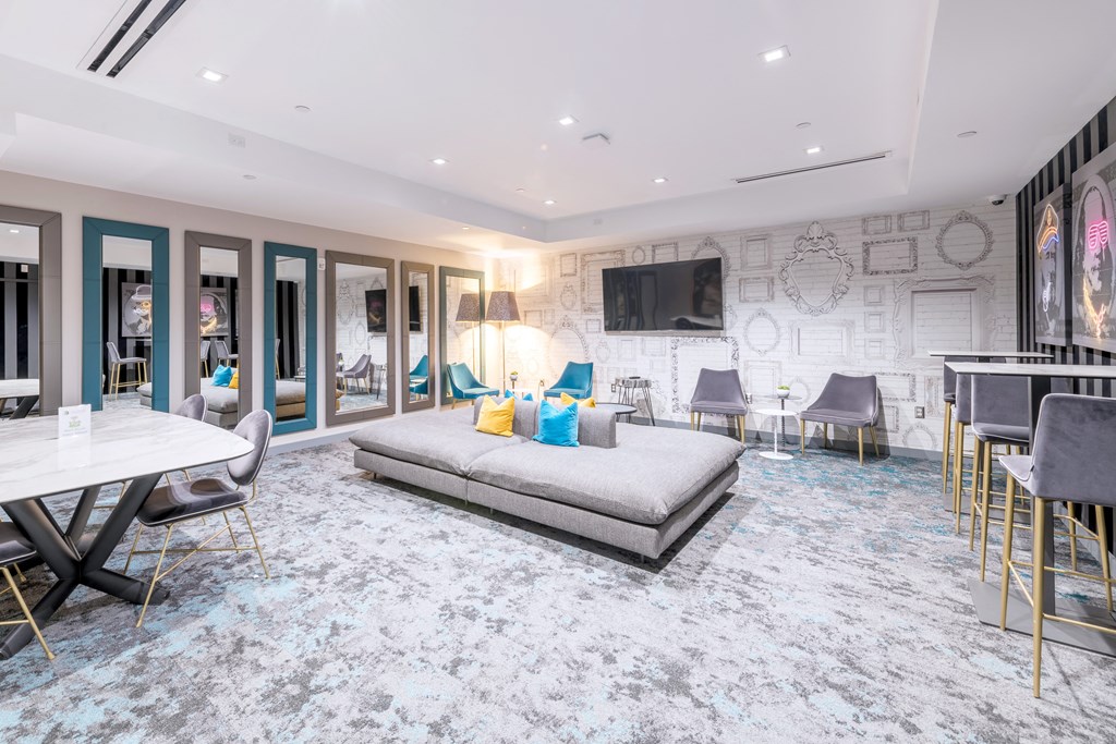 a living room with a bed and a table and chairs