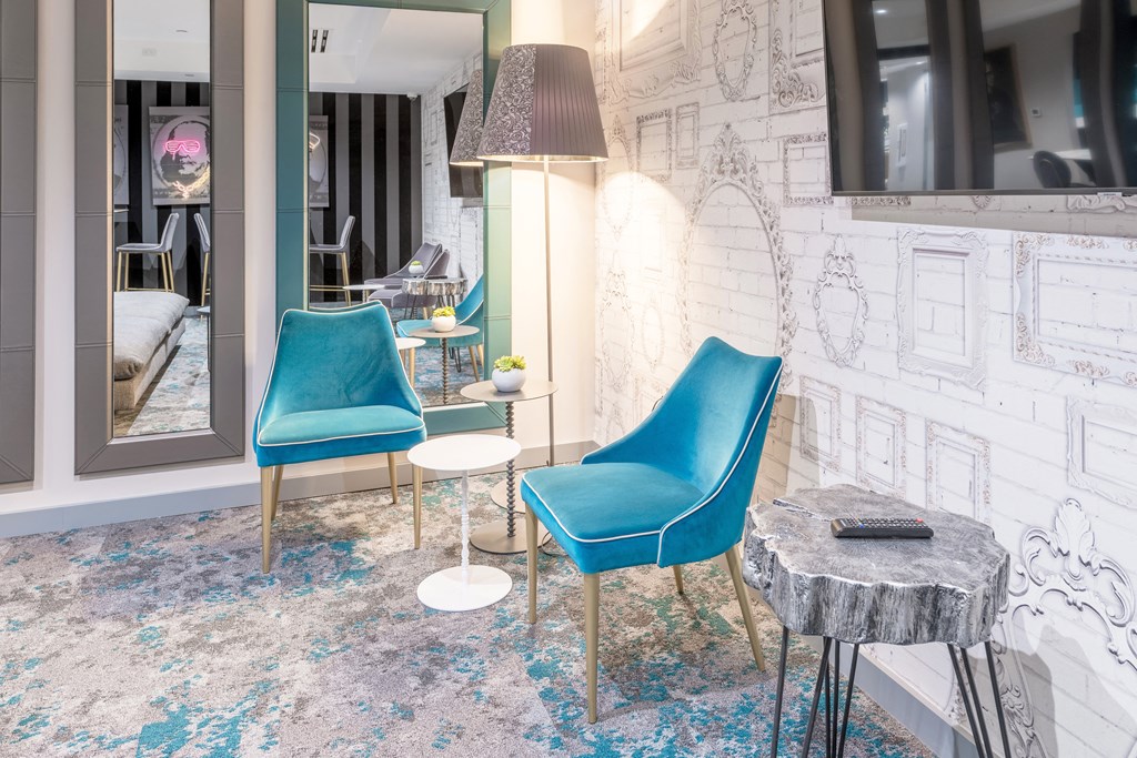 a living room with two blue chairs and a table