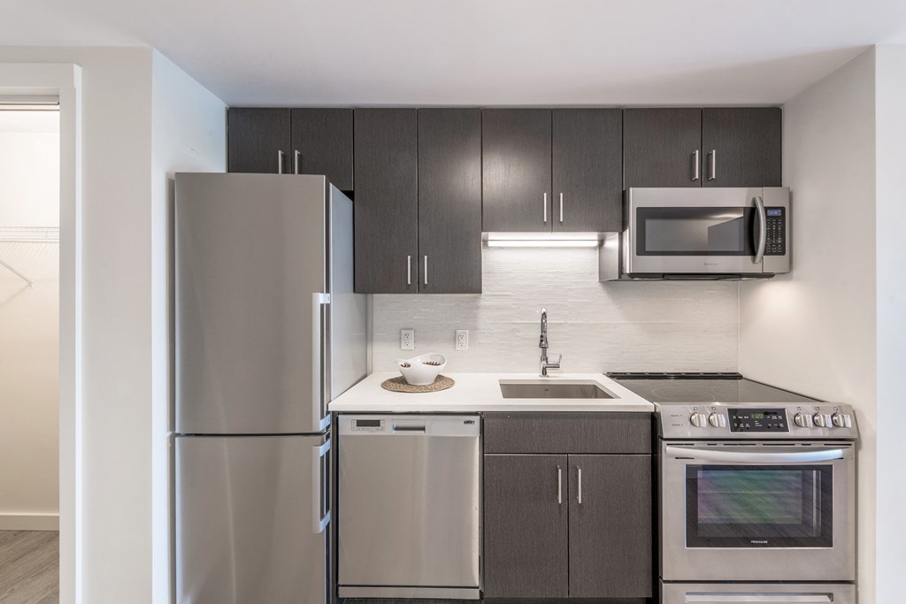 a kitchen with stainless steel appliances and a stainless steel refrigerator