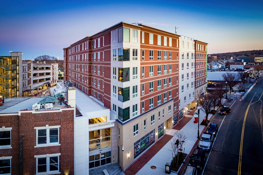 an aerial view of a building in the city at dusk
