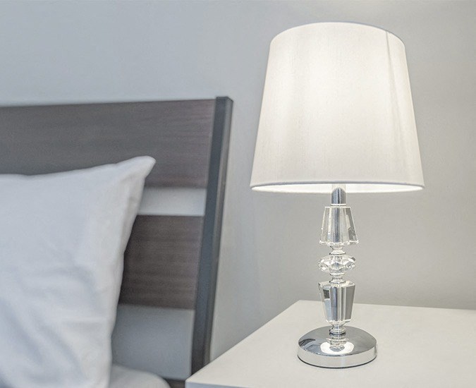 white lamp on a night table