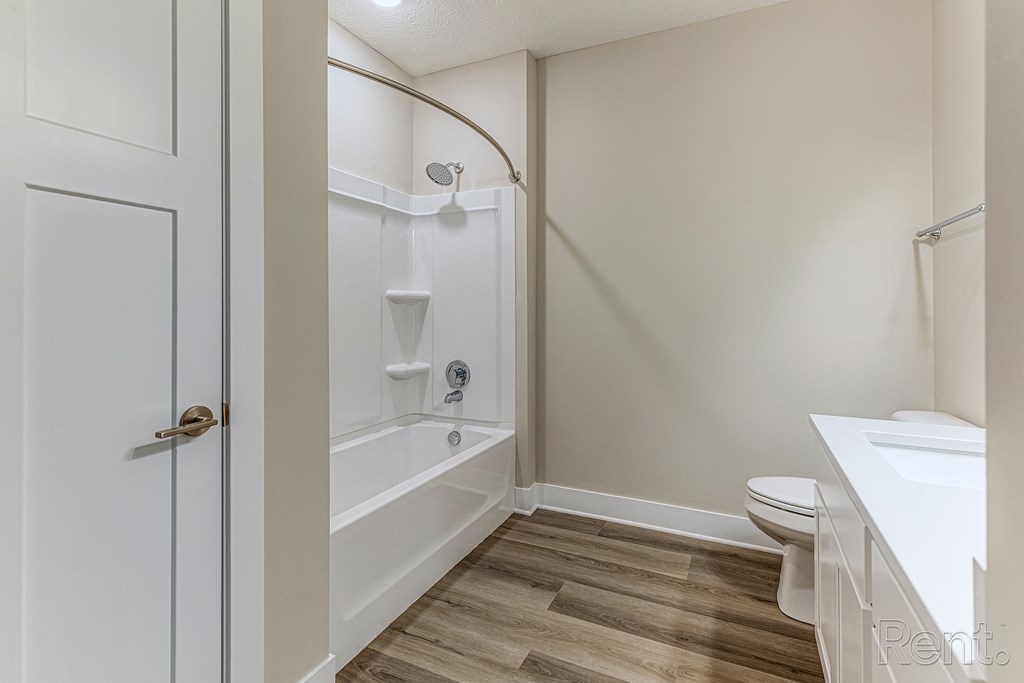 A white bathroom with a toilet, sink, and bathtub.at Tiffany Flats, Columbus, OH