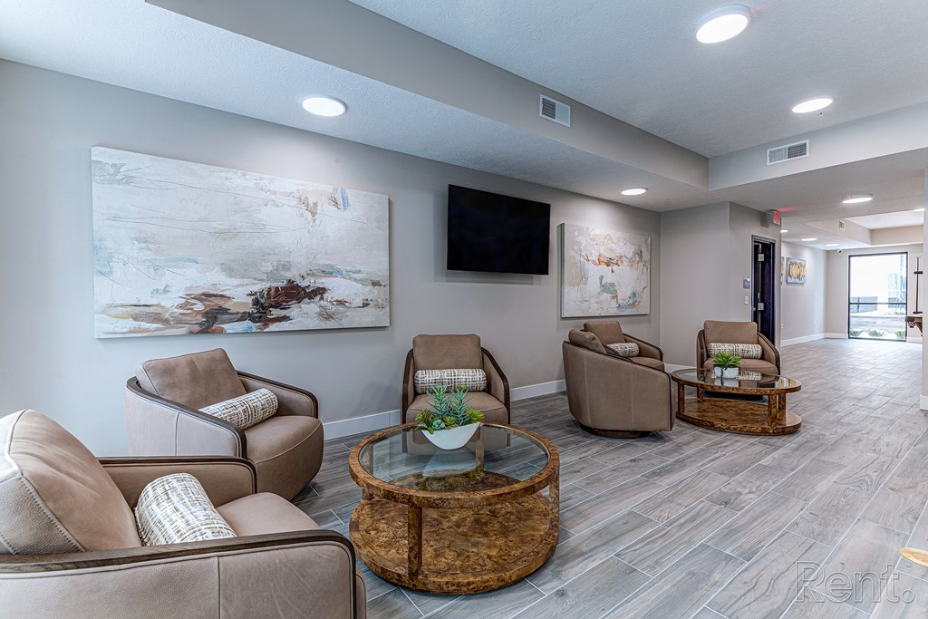 A living room with a large painting on the wall and a flat screen TV.at Tiffany Flats, Columbus, OH