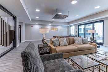 A living room with a couch, armchair, and coffee table.