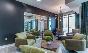 A living room with a large mirror and a variety of chairs.