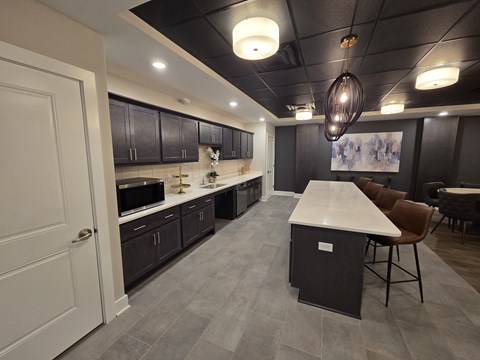 A modern kitchen with dark wood cabinets and a white island.