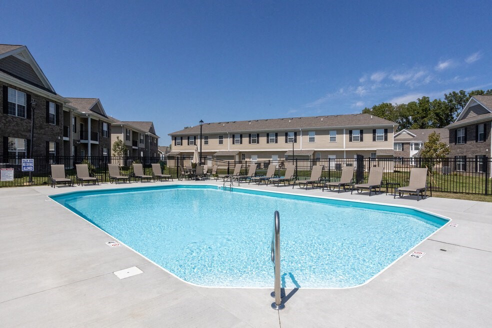a swimming pool in front of an apartment building