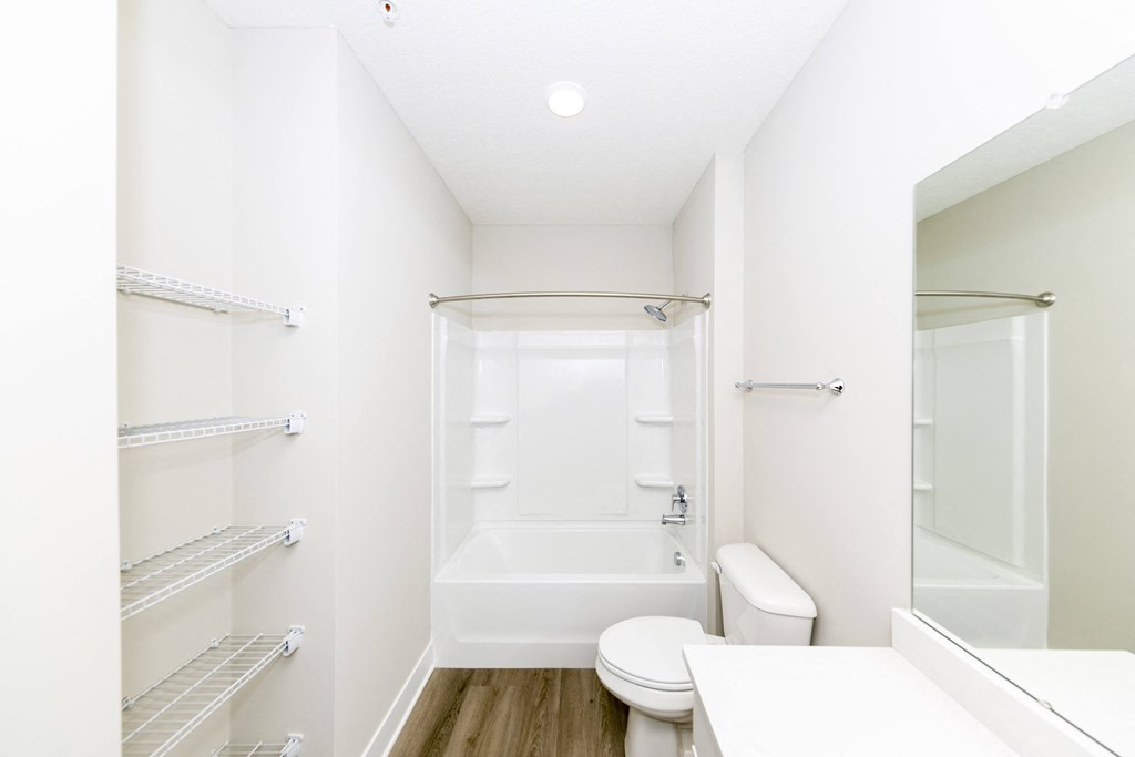 A white bathroom with a toilet, sink, and bathtub.at Tiffany Flats, Columbus