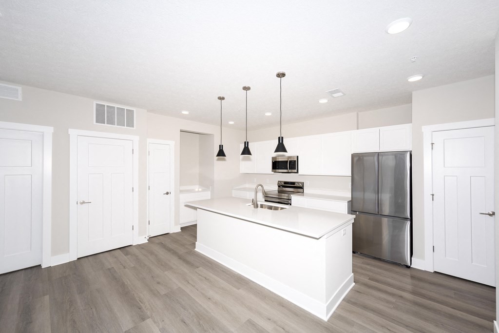 A kitchen with a white island and stainless steel appliances.at Tiffany Flats, Ohio, 43231