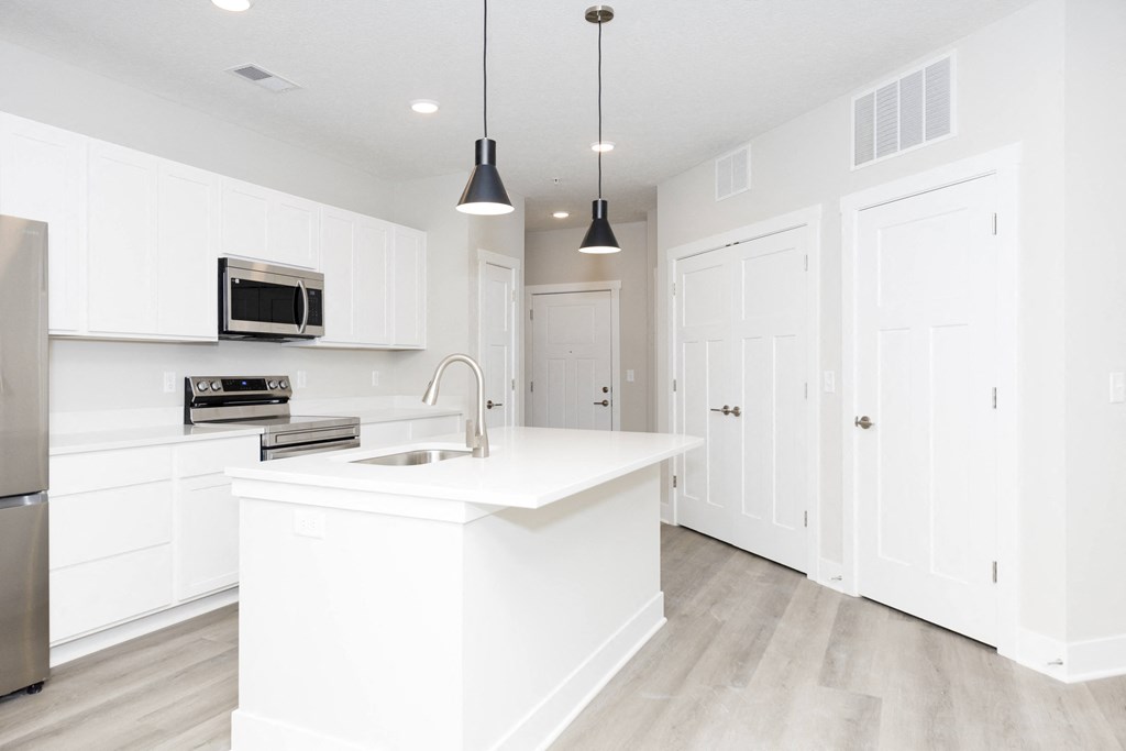 A white kitchen with a sink and a microwave.at Tiffany Flats, Ohio, 43231