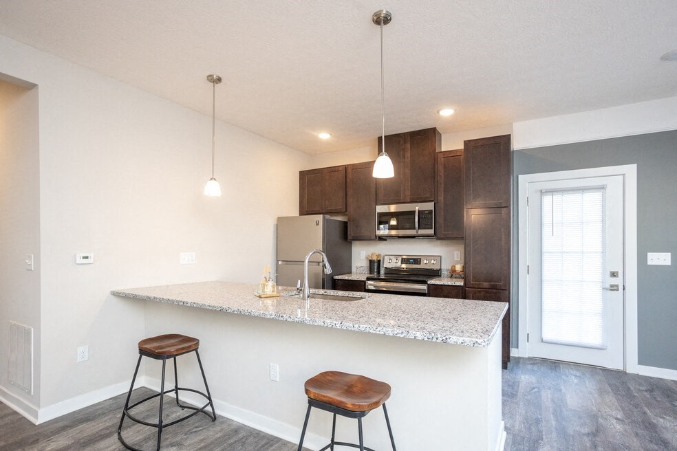 a kitchen with a counter top with two stools