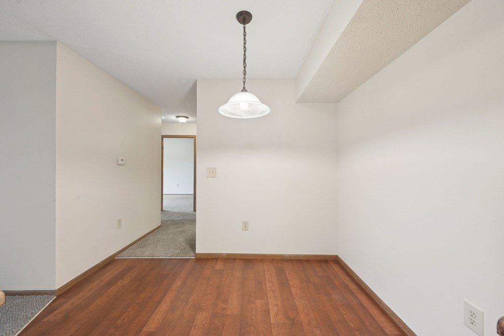 A room with a wooden floor and a white ceiling.