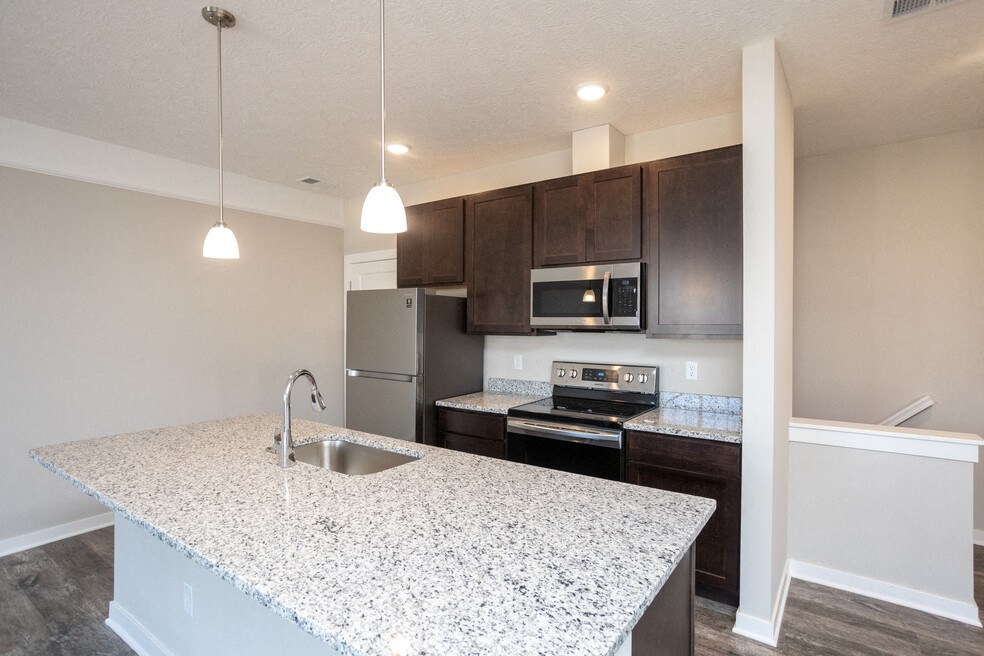a kitchen with a granite counter top and a sink