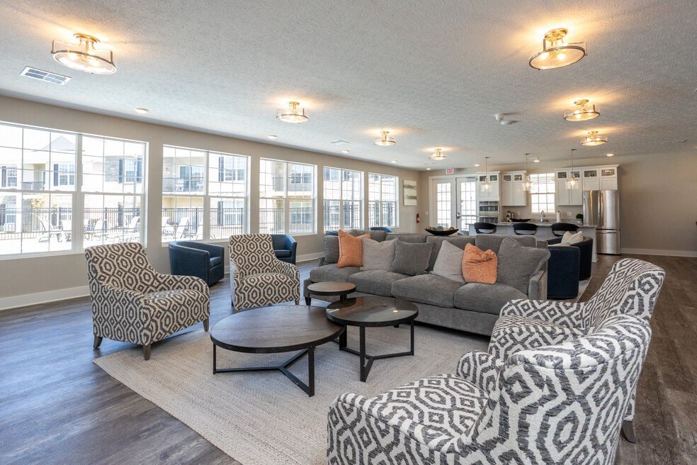 a living room with couches and chairs and a large window