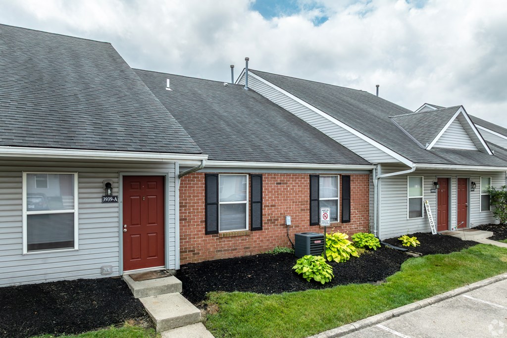 A house with a red door and a grey roof.