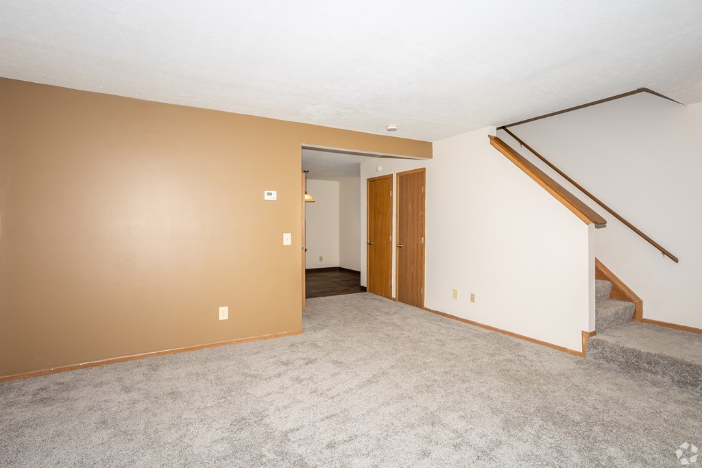 A room with a staircase and a door.