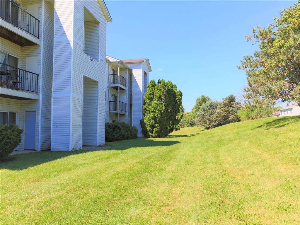 a large lawn in front of a white house