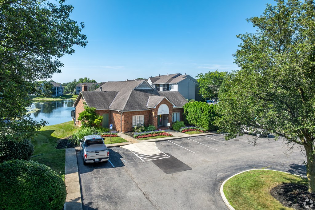 A house with a driveway and a car parked in front.