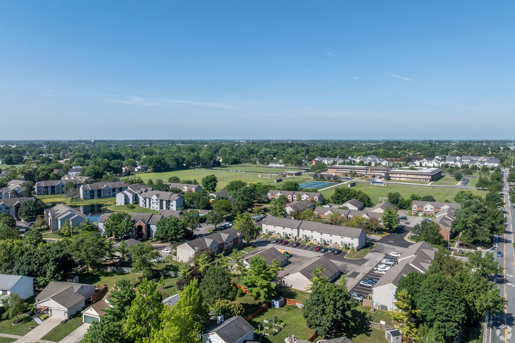 A bird's eye view of a residential area with houses and trees.
