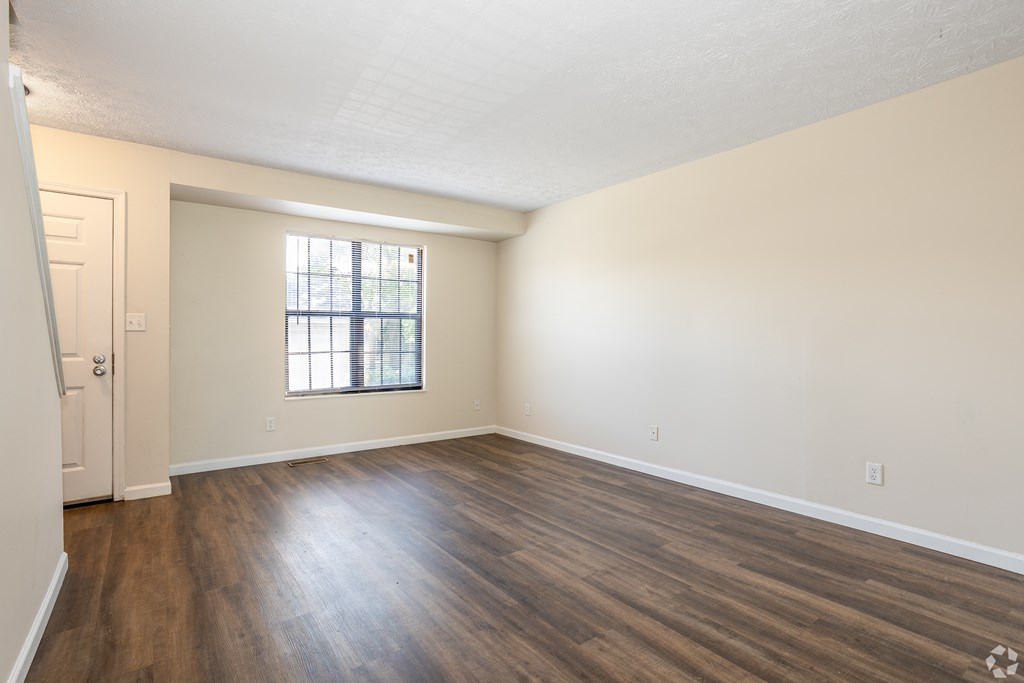 A room with wooden floors and a window.