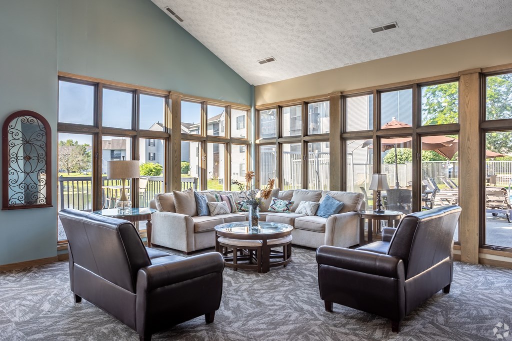A living room with a large window and a view of a backyard.