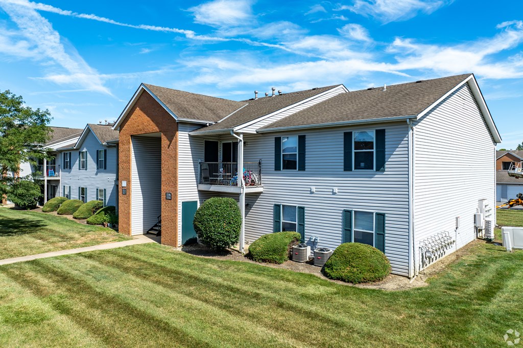 A house with a white exterior and a brown roof.