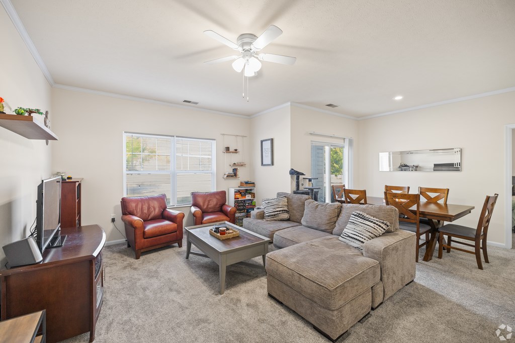 a living room with a couch and a table with chairs