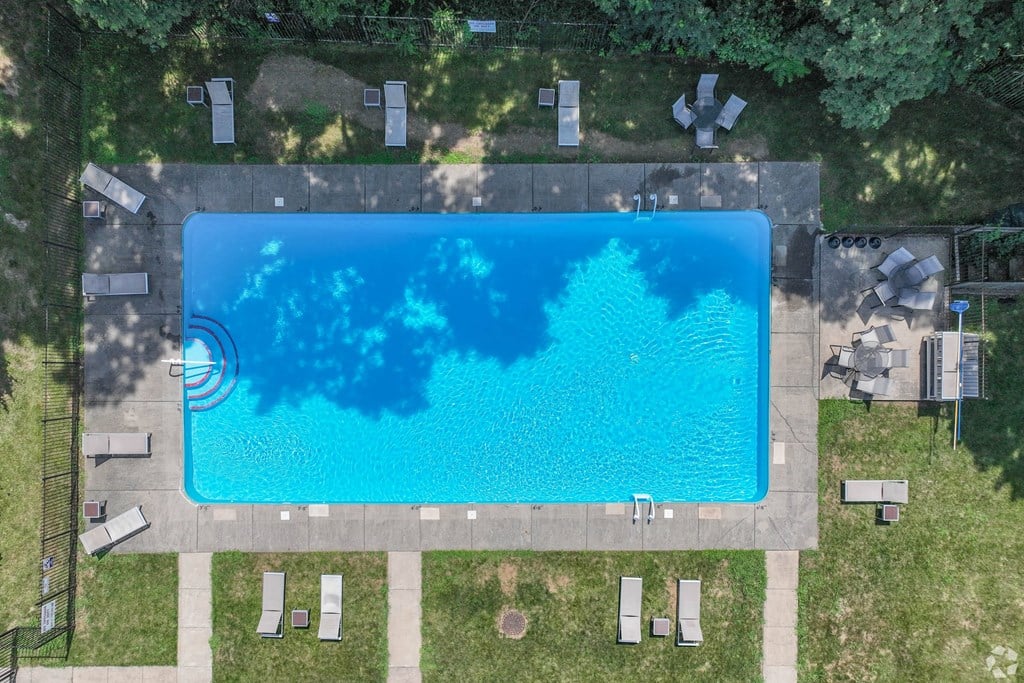 An aerial view of a swimming pool surrounded by lounge chairs.