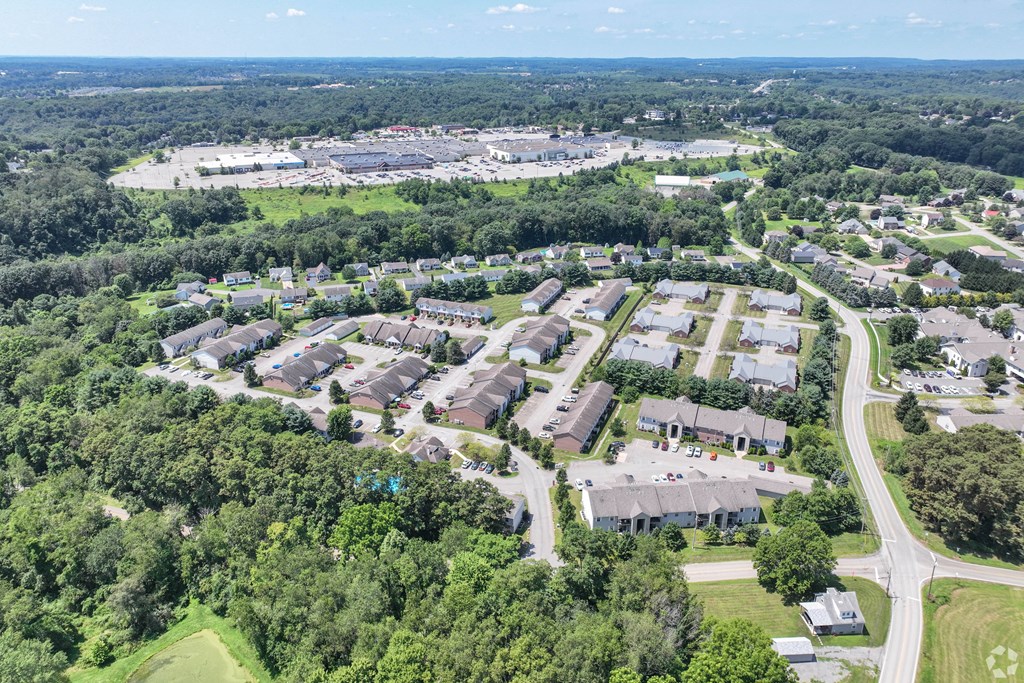 A bird's eye view of a residential area with houses and a road.