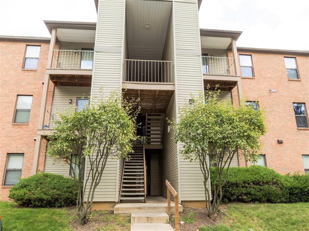 a brick apartment building with stairs and a balcony