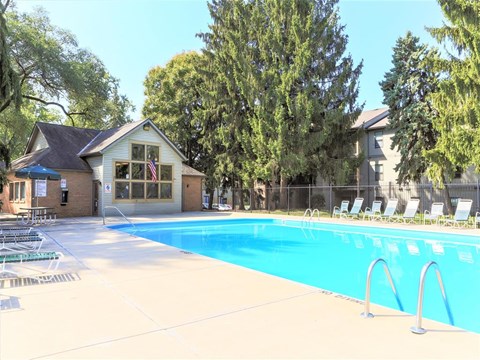 A pool with a building behind it.