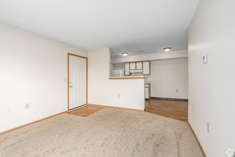 A room with a carpeted floor and a door.