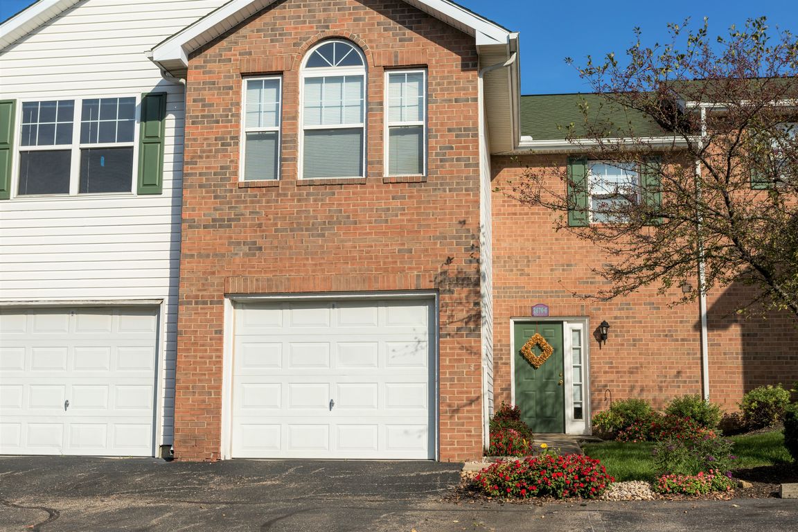 a brick house with a white garage door